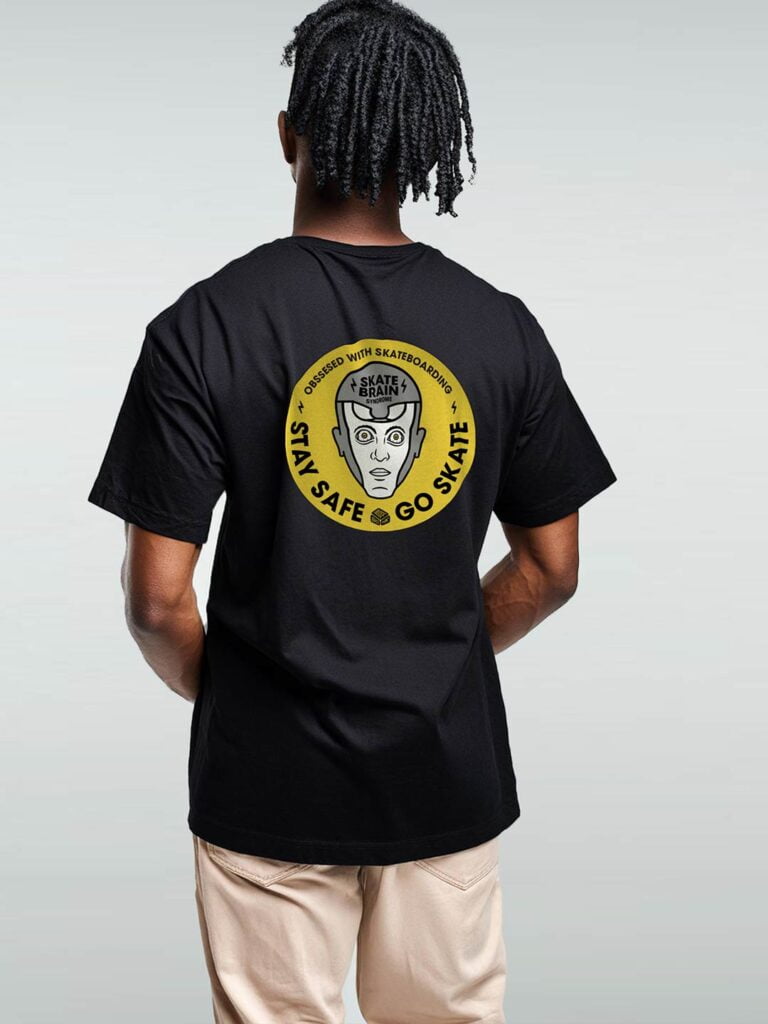 Unique Black T-Shirt with a yellow circle graphic of a skate ramp inside a brain and 'Obsessed with Skateboarding - Stay Safe Go Skate' text. Unique Skate Shirts