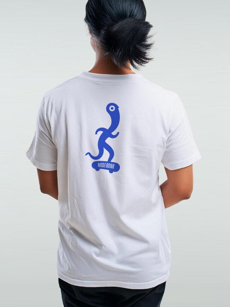 White T-Shirt with a blue abstract figure pushing a skateboard. Unique Skate Graphics Shirt