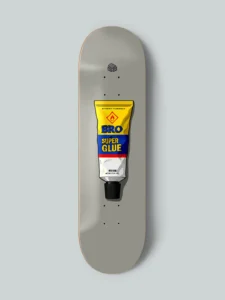 Skateboard deck design by Nosebonk – featuring a retro super glue tube labeled "BRO", centered on a grey board with realistic shadows and packaging details.