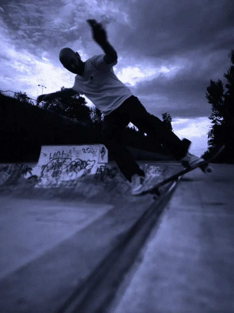 Skateboarding night session in Torrelodones, Madrid at La Kantorre — skater doing a no comply on the mini ramp, Nosebonk crew.