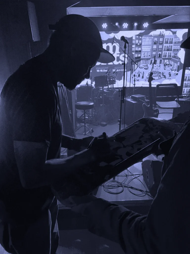 Ray Barbee signing skateboards for the Nosebonk Crew before his concert at El Sótano in Madrid — music, skate and community on the same stage.